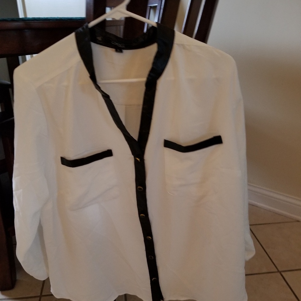 White top with faux leather trim.